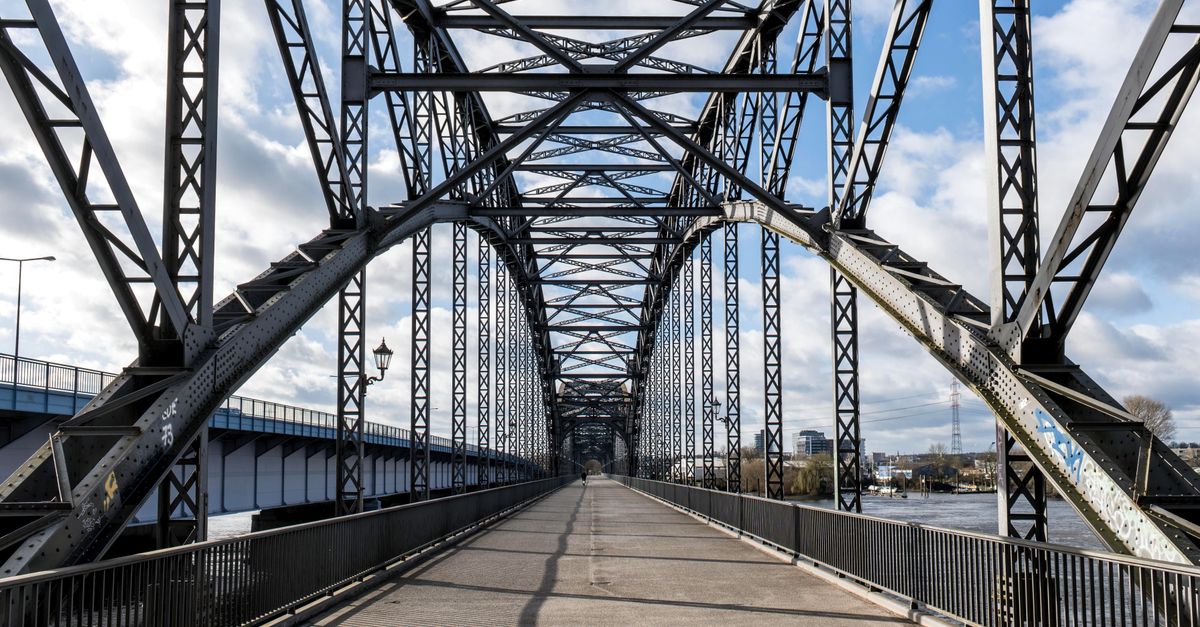 A striking steel arch bridge structure in Hamburg, Germany, under a bright sky.